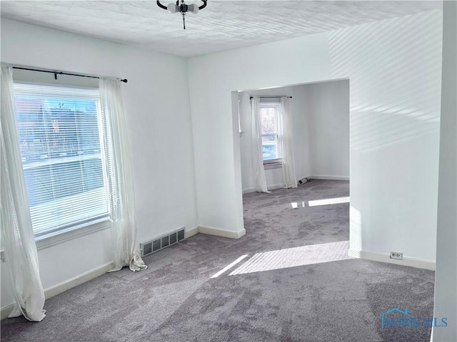 unfurnished room featuring carpet