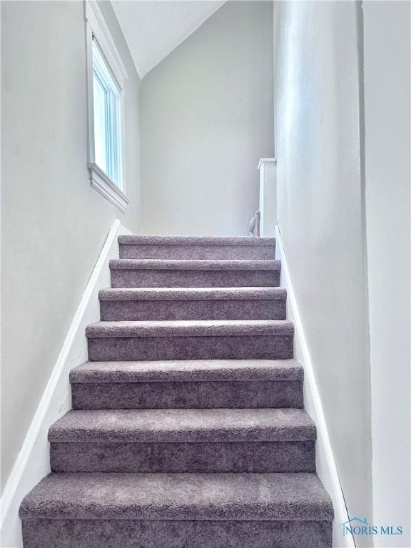 stairs featuring lofted ceiling