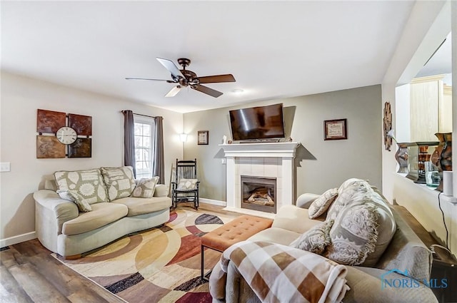 living room with a fireplace, hardwood / wood-style flooring, and ceiling fan