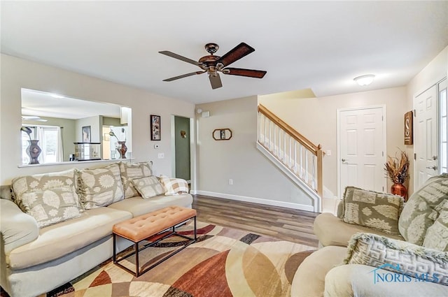 living room with light hardwood / wood-style flooring and ceiling fan