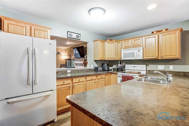 kitchen with light brown cabinetry, sink, and white appliances