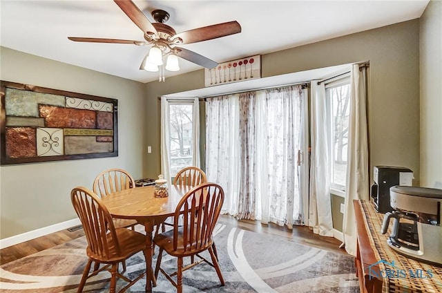 dining space with hardwood / wood-style flooring and ceiling fan