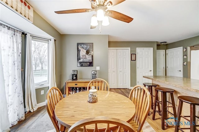 dining space featuring ceiling fan and light hardwood / wood-style floors