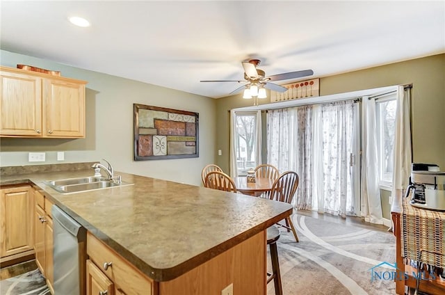 kitchen featuring a wealth of natural light, sink, stainless steel dishwasher, and light brown cabinets