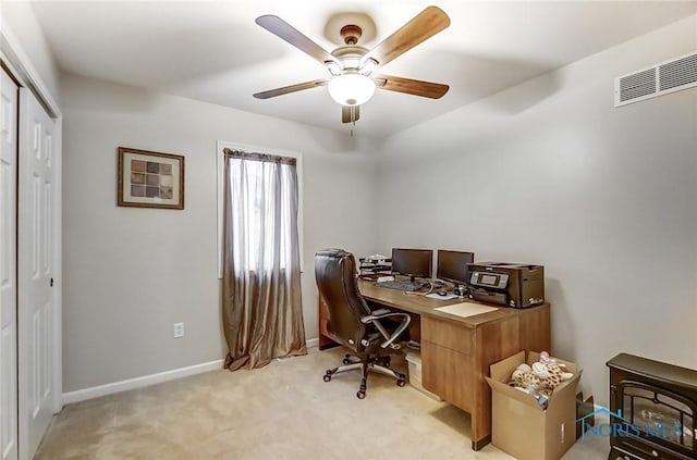 office space with light colored carpet and ceiling fan