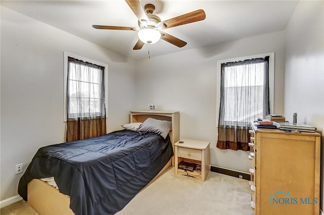 bedroom featuring light colored carpet and ceiling fan