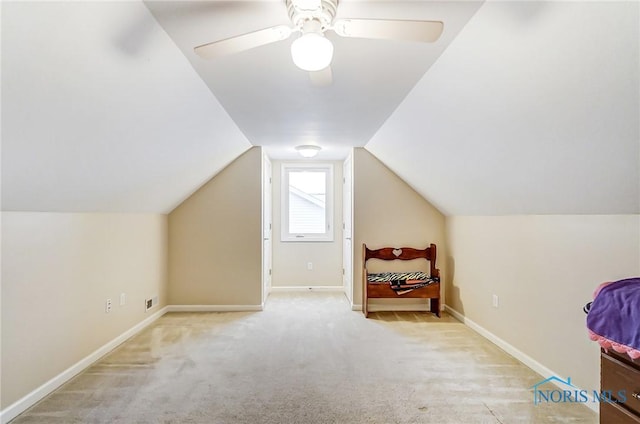 additional living space featuring ceiling fan, lofted ceiling, and light carpet