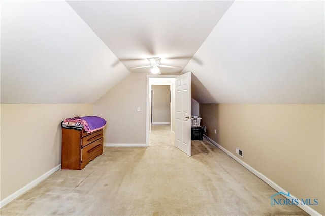 additional living space featuring light colored carpet, vaulted ceiling, and ceiling fan