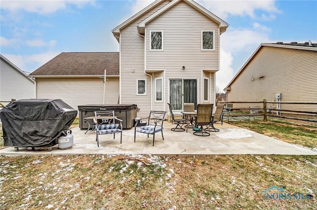 back of property with a patio and a hot tub