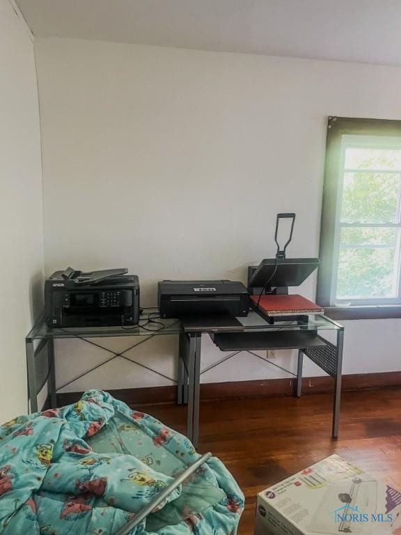 bedroom with dark hardwood / wood-style flooring