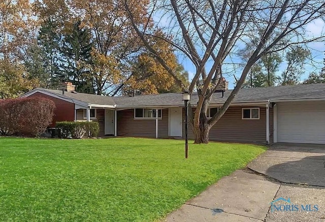 single story home featuring a front yard and a garage