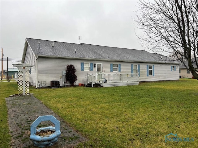 back of house with a wooden deck, a yard, and cooling unit