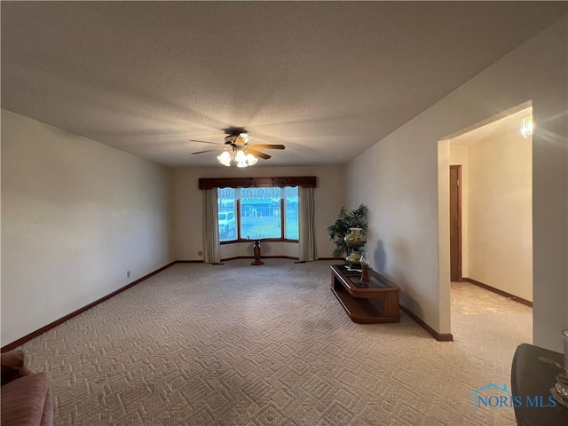 carpeted spare room with ceiling fan and a textured ceiling