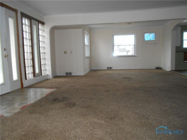 foyer with carpet floors and ornamental molding