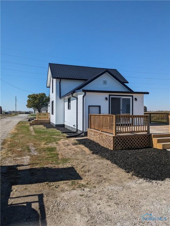 rear view of house featuring a deck