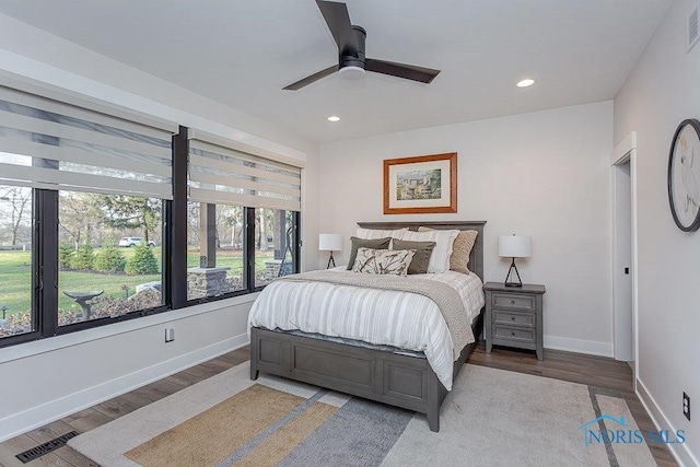 bedroom with ceiling fan and wood-type flooring