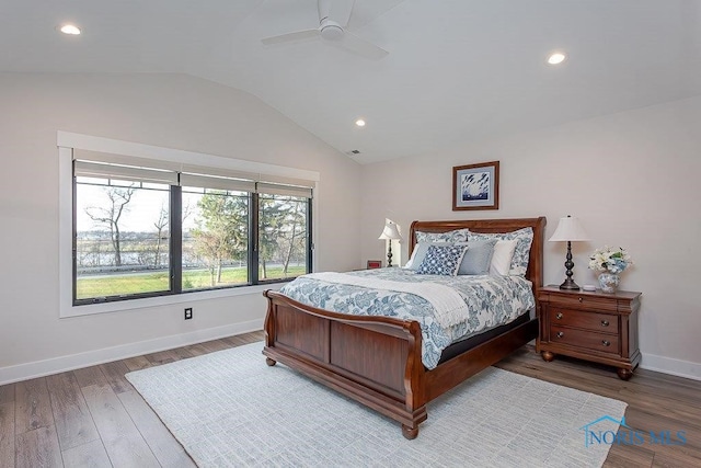 bedroom featuring ceiling fan, wood-type flooring, and lofted ceiling