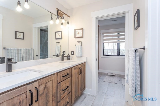 bathroom featuring hardwood / wood-style flooring and vanity