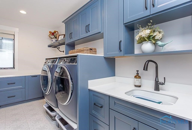 washroom featuring cabinets, independent washer and dryer, and sink