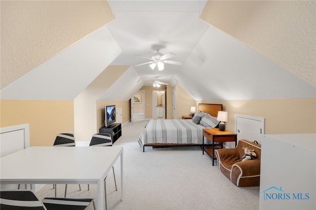 bedroom with light colored carpet, ceiling fan, and lofted ceiling