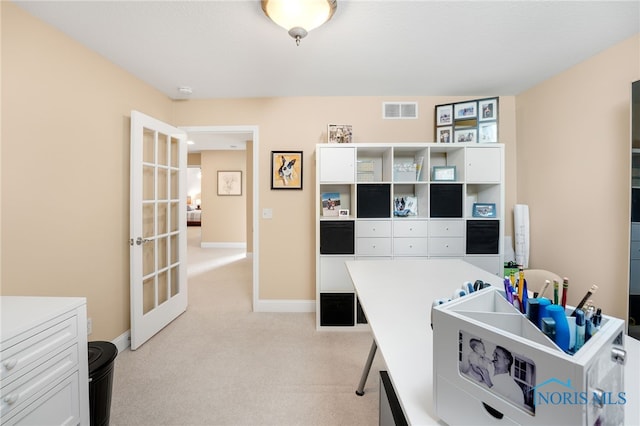 office space featuring light carpet and french doors