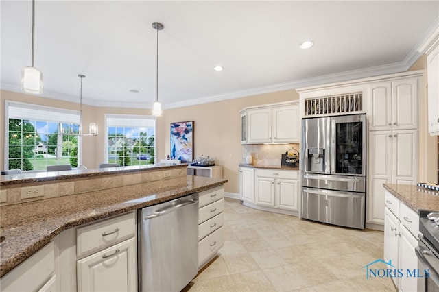 kitchen featuring stone counters, crown molding, appliances with stainless steel finishes, decorative light fixtures, and white cabinetry