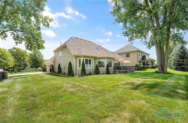 rear view of property with a lawn