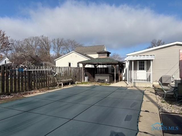 view of pool featuring a gazebo, a jacuzzi, a patio, and central AC unit