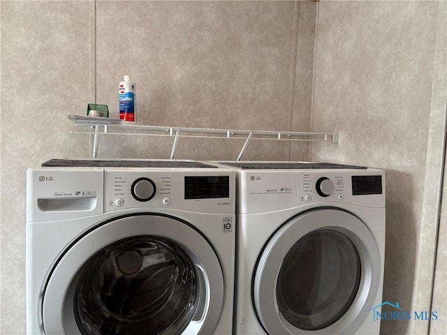 clothes washing area with washing machine and clothes dryer