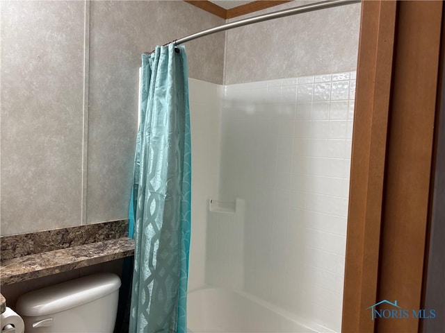 bathroom with toilet and shower / tub combo