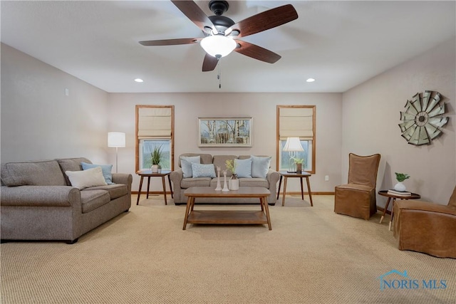 carpeted living room featuring ceiling fan