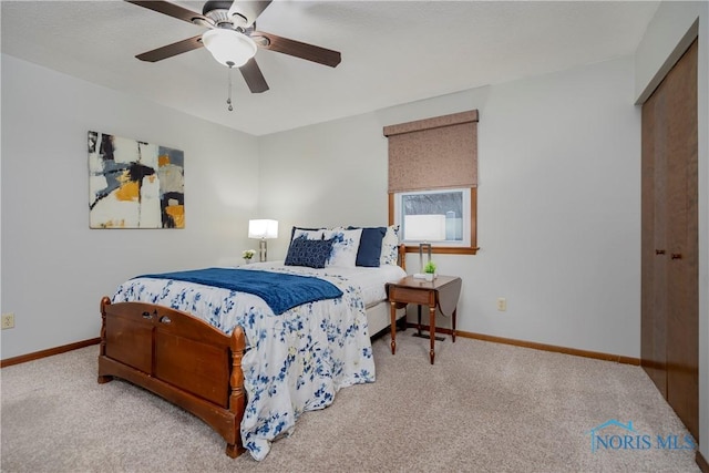 carpeted bedroom with ceiling fan and a closet