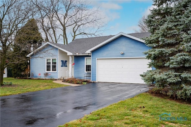 ranch-style home featuring a garage and a front yard