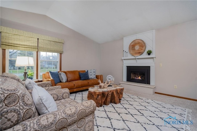 living room with light carpet, a fireplace, and vaulted ceiling