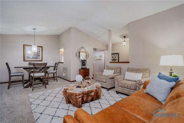 living room featuring light carpet and vaulted ceiling