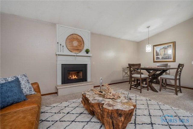 living room with lofted ceiling, carpet floors, and a fireplace