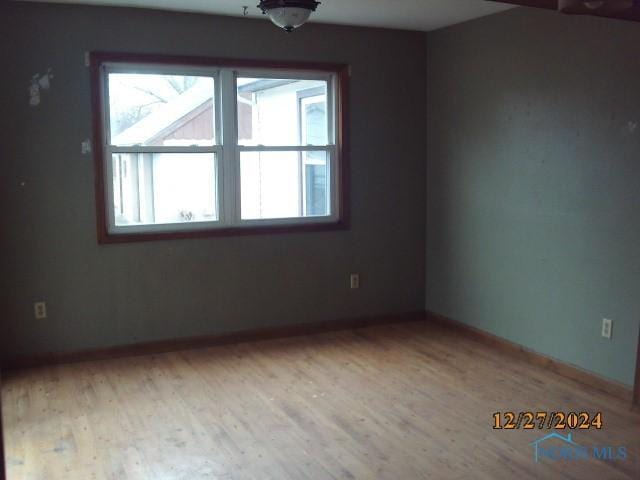 spare room featuring light hardwood / wood-style floors