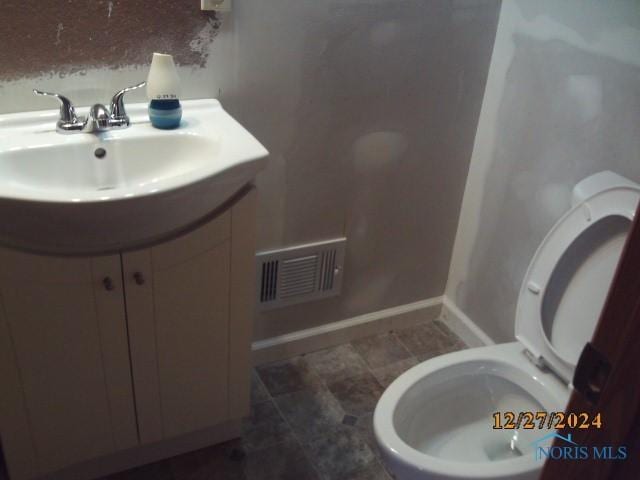 bathroom with vanity and toilet