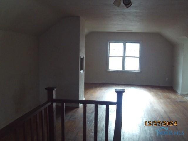 bonus room featuring hardwood / wood-style flooring and vaulted ceiling