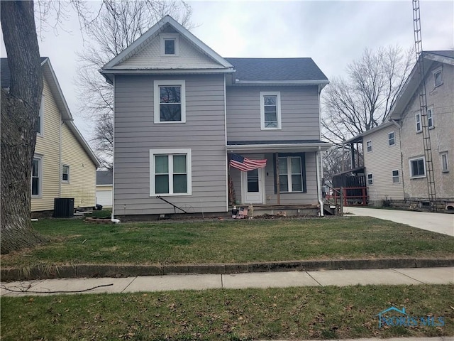 front of property with a front yard and central air condition unit