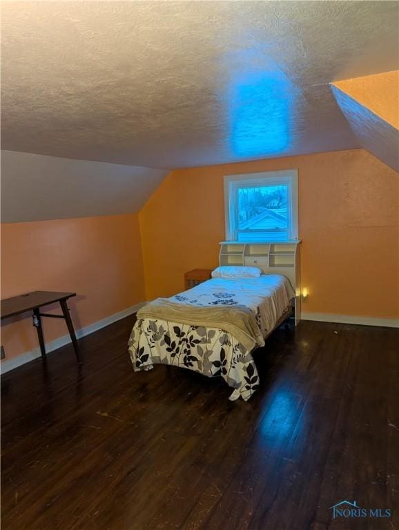 bedroom featuring dark hardwood / wood-style floors and a textured ceiling