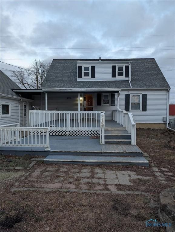 rear view of property with central air condition unit and a deck