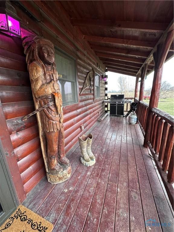 wooden deck with a grill