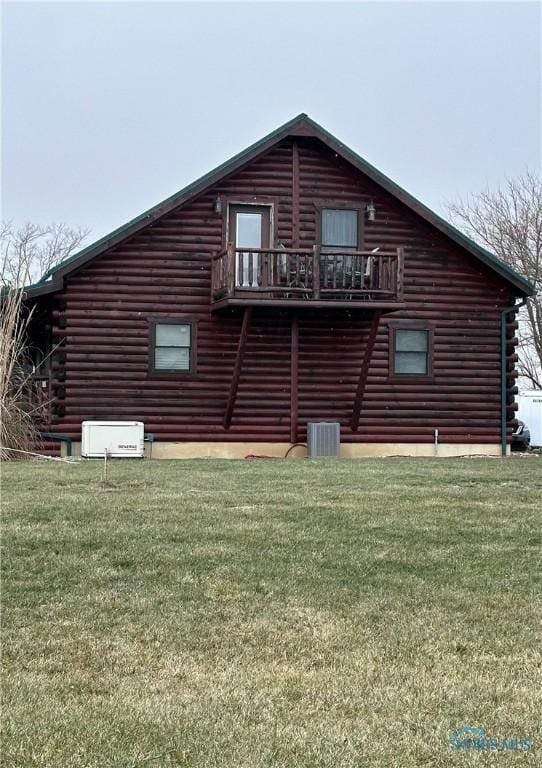 exterior space featuring a lawn, log siding, and central AC unit