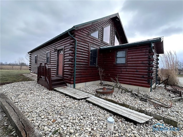 view of property exterior with log exterior