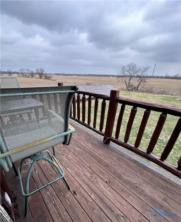 deck featuring a rural view and a lawn