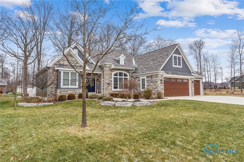 view of front of property with a front yard and a garage