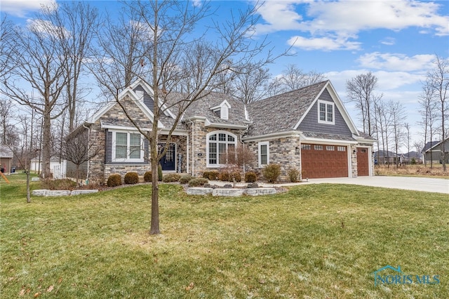 view of front of property with a front yard and a garage