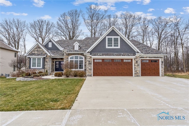 craftsman inspired home with a garage, central air condition unit, and a front lawn