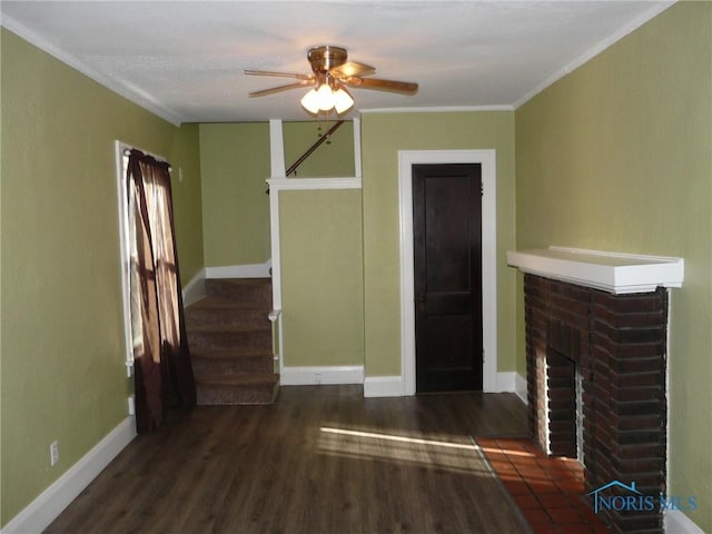 unfurnished living room with dark hardwood / wood-style flooring, ceiling fan, a fireplace, and ornamental molding